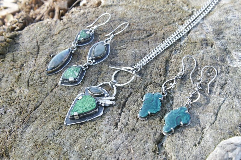 a close up of a rock with some jewelry on it
