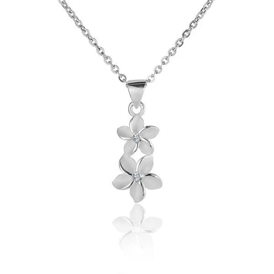 Two Plumeria CZ pendants, 6/8mm size, featuring sparkling cubic zirconia stones in a floral design, perfect for jewelry making.