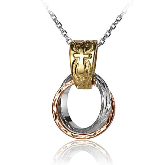 Two scroll rings and a large bell pendant from Ashley's Gift Shop, featuring intricate metalwork and decorative design.