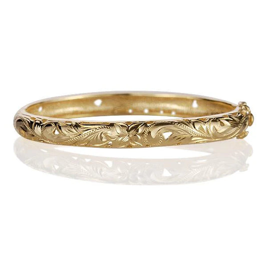 Oval yellow gold plated bangle from Ashley's Gift Shop featuring a sleek, stylish design with a smooth finish.