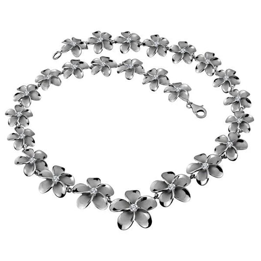 Rhodium-plated Plumeria necklace with 15-25mm floral pendant, featuring intricate design and chain, by Ashley's Gift Shop.