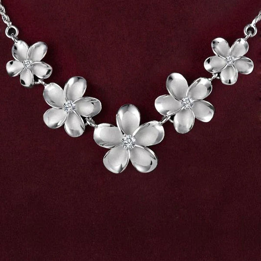 Rhodium-plated Plumeria rope necklace by Ashley's Gift Shop with 12-18mm thick braided design, shown on a display.