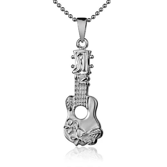 Ukulele with two plumeria pendant charms, featuring a wooden body and string details, displayed on a neutral background.