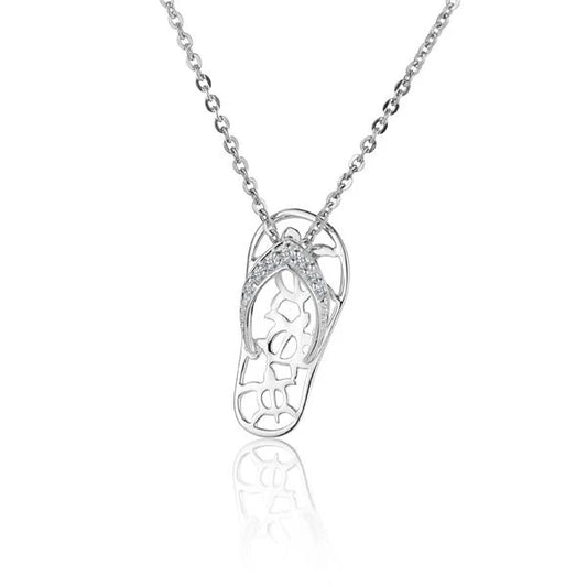 Silver 7CZ 3Honu slipper pendant with cubic zirconia accents, handcrafted jewelry by Ashley's Gift Shop on a plain background.