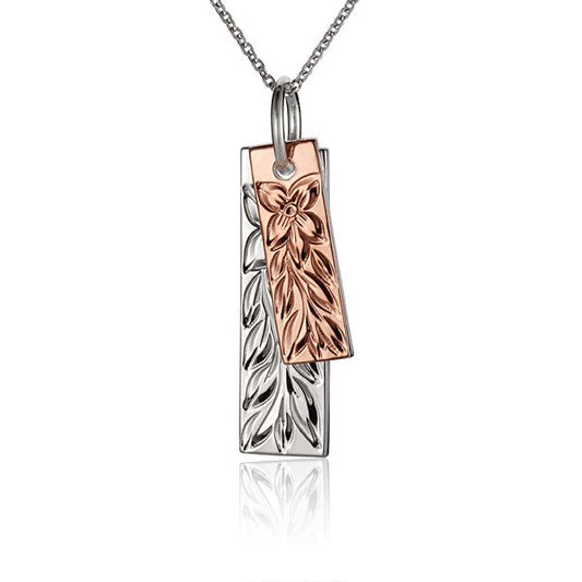 Double Maile PG+SS pendant from Ashley's Gift Shop featuring intricate gold and silver chain links, close-up view of the pendant.