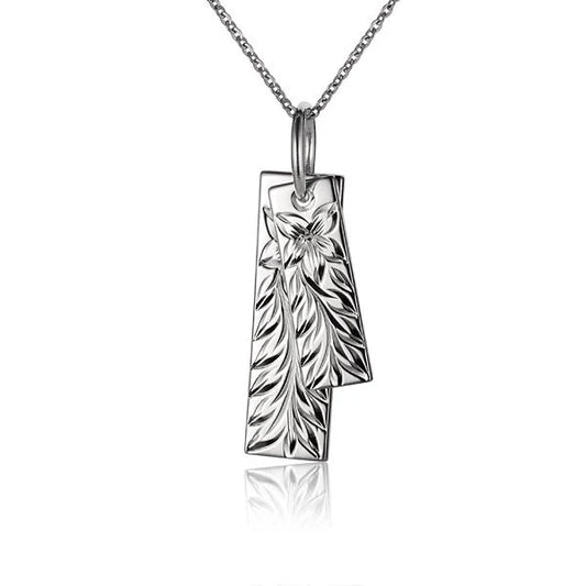 Double plate Maile pendant necklace from Ashley's Gift Shop, featuring intricate ocean-inspired design and shiny silver finish.