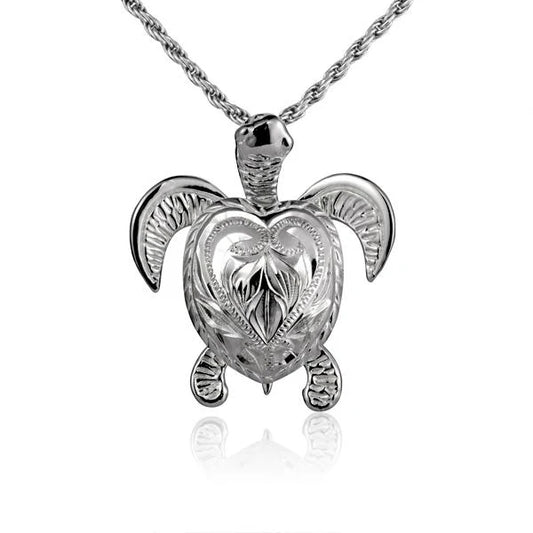 Engraved scroll turtle pendant in silver with intricate scroll design, necklace chain visible, crafted by Ashley's Gift Shop.