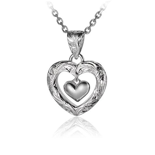 Engraved heart pendant with dangling heart charm, made by ESP Engr. for Ashley's Gift Shop, shown in close-up on a jewelry display.