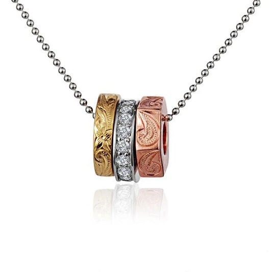 Tri-color three-ring pendant with CZ engravings, featuring layered design and vibrant metal finishes, by Ashley's Gift Shop.