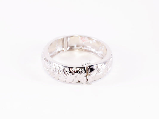 Silver Hawaiian bangle bracelet with intricate island-inspired design, crafted by Ashley's Gift Shop.