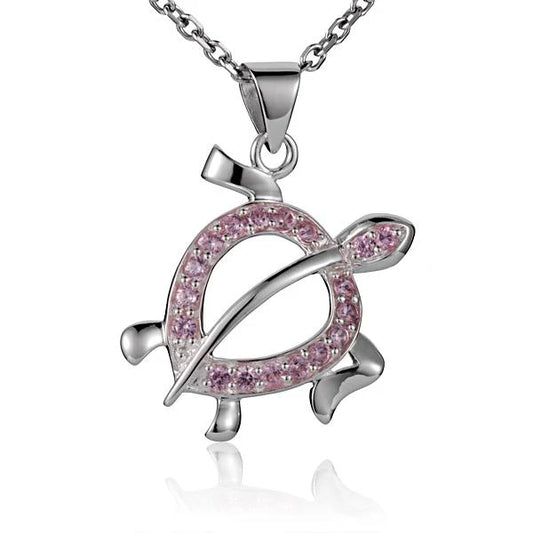 Pink CZ pendant featuring a honu turtle design, crafted by Ashley's Gift Shop, showcased on a jewelry display.