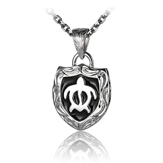 Honu turtle pendant with enamel and scroll design, crafted by Ashley's Gift Shop, featuring intricate detailing and vibrant colors.