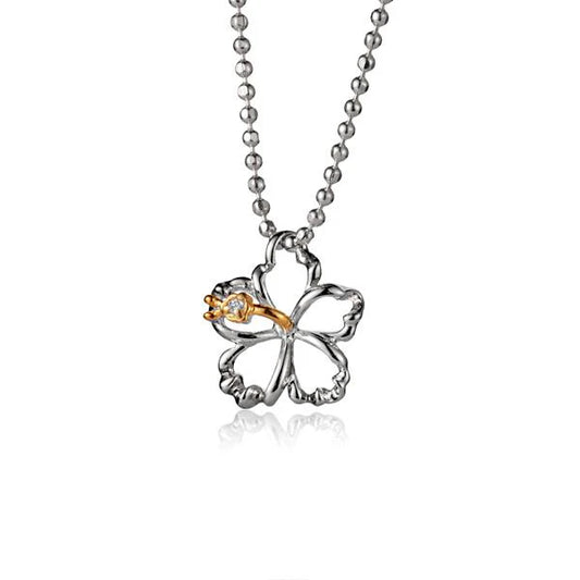 Outline hibiscus CZ pendant in yellow gold 2-tone, 10mm, featuring detailed floral design and sparkling cubic zirconia accents.