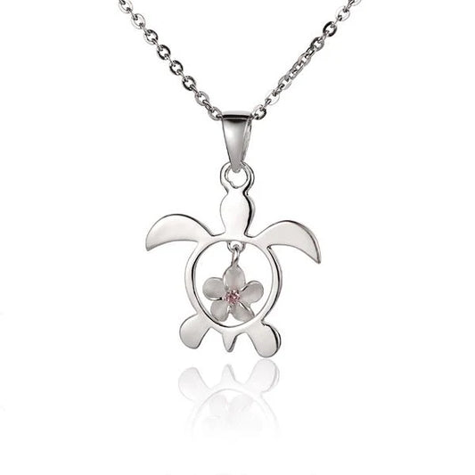Plumeria flower in a Honu turtle pendant, crafted by Ashley's Gift Shop, featuring detailed design and ocean-inspired motifs.