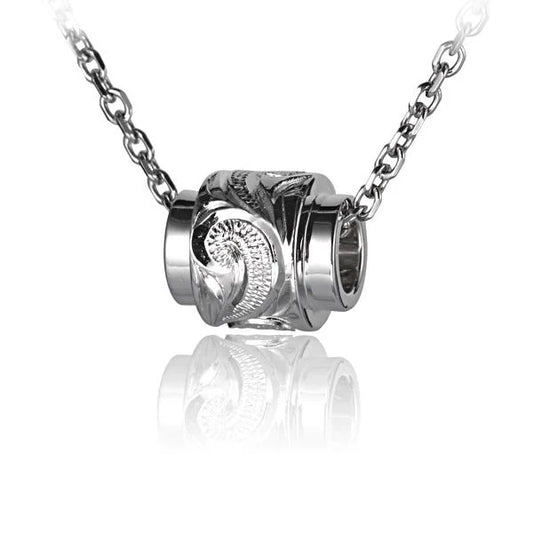 Raised scroll barrel pendant necklace featuring intricate metalwork and a vintage design, crafted by Ashley's Gift Shop.