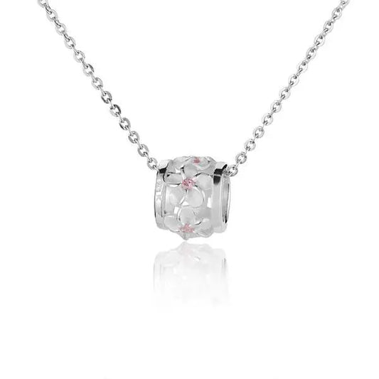 Sterling silver S/Blasted Plumeria CZ barrel charm in size M with engraved floral design, by Ashley's Gift Shop.