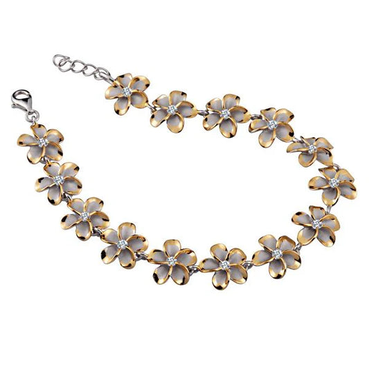 Sterling silver Plumeria CZ bracelet with yellow gold plating, 12mm width, featuring floral design and sparkling gemstone accents.