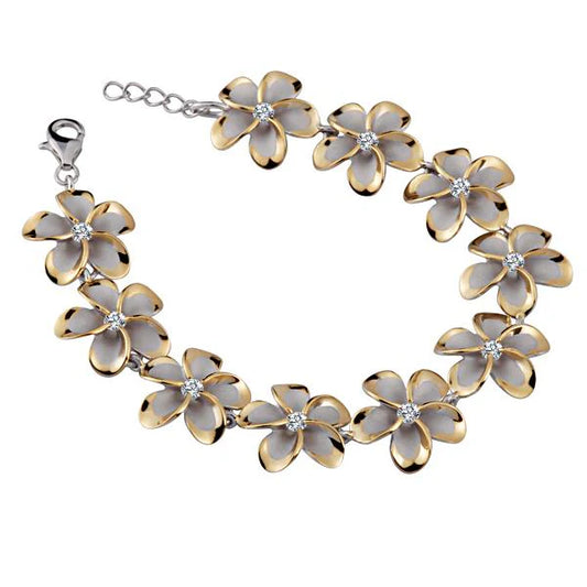 Sterling silver Plumeria CZ bracelet with yellow gold plating, 18mm width, featuring floral design and sparkling gemstones.