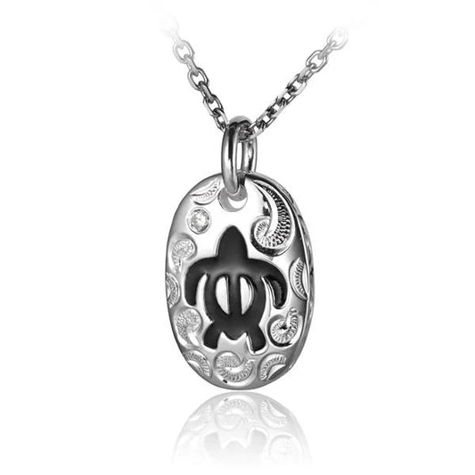 Oval black Honu CZ pendant from Ashley's Gift Shop featuring a tropical turtle design on a silver-tone setting.