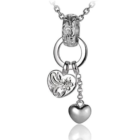 Ashley’s Gift Shop scroll bell with two heart pendants, featuring intricate design and hanging charms.