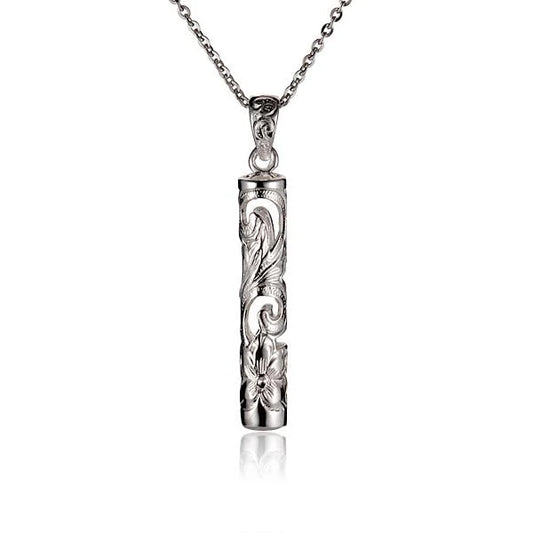 Small scroll tube pendant by Ashley's Gift Shop featuring a detailed metal scroll design on a sleek pendant.