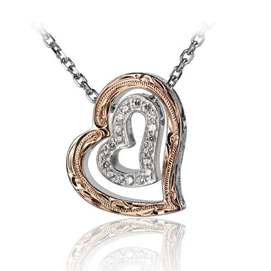 Silver scroll and CZ heart pendant from Ashley's Gift Shop, featuring intricate design and sparkling cubic zirconia accents.