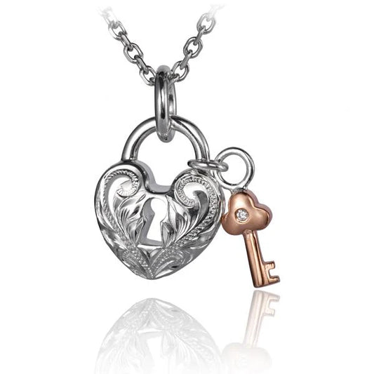 Gold scroll heart pendant with key charm, elegant jewelry piece from Ashley's Gift Shop, featuring intricate design on a delicate chain.