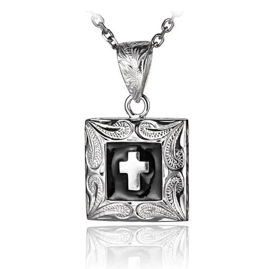 Black cross pendant with scroll plate design, featuring intricate details, from Ashley's Gift Shop.