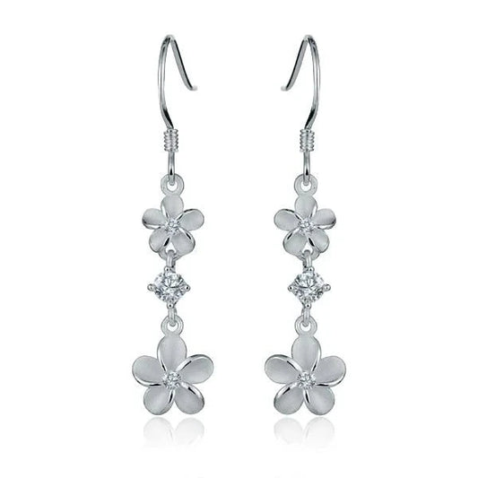 Sterling silver Plumeria CZ earrings featuring delicate flower designs, perfect for elegant and casual wear.