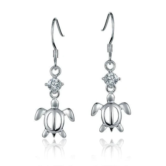Sterling silver CZ and Honu dangle earrings featuring intricate ocean-inspired designs, crafted by Ashley's Gift Shop.