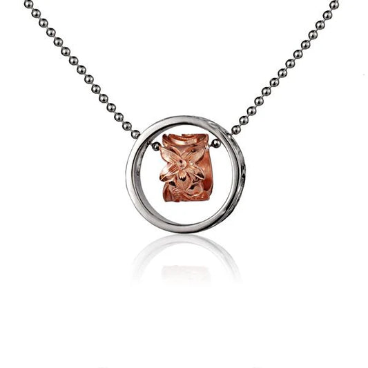 Pink scroll ring pendant with a decorative circular design, displayed on a white background. Crafted by Ashley's Gift Shop.