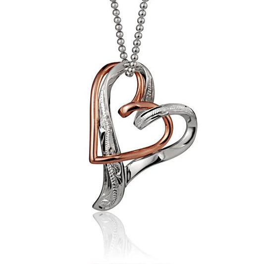 Sterling silver floating engraved double heart pendant with intricate details, designed for elegant jewelry wear.