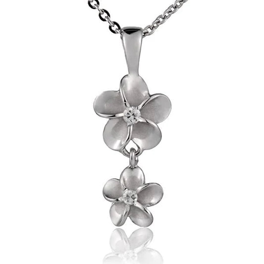 Sterling silver Plumeria CZ pendant with 10/8mm gemstones, crafted in rhodium finish, featuring a floral design.