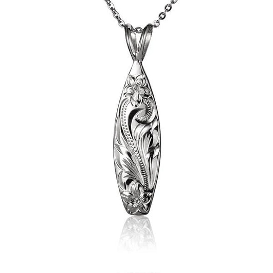 Gold surfboard pendant necklace with textured surfboard design, from Ashley's Gift Shop, on a chain.