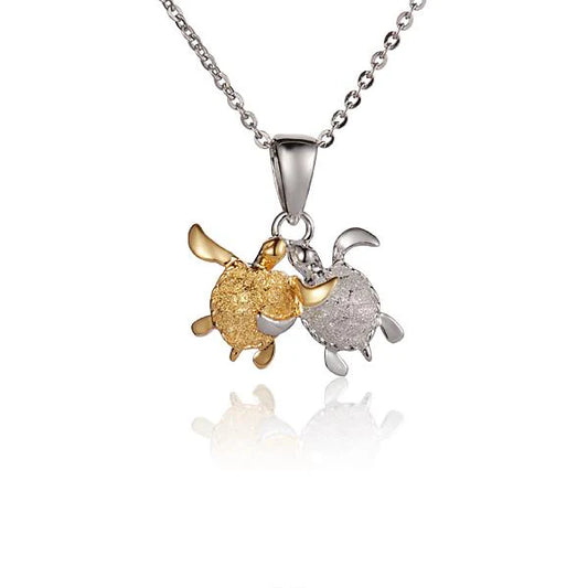 Twin turtle pendant featuring two turtles with detailed carvings, crafted by Ashley's Gift Shop.